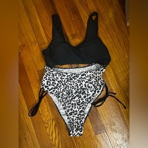 One piece draw string bathing suit.